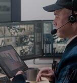 Security,Officer,In,Headset,Controls,And,Monitors,Cctv,Cameras,In