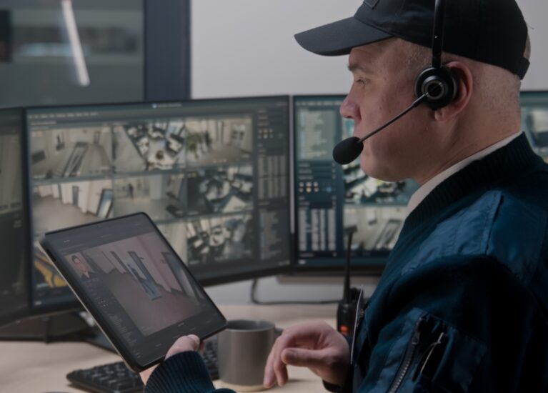 Security,Officer,In,Headset,Controls,And,Monitors,Cctv,Cameras,In