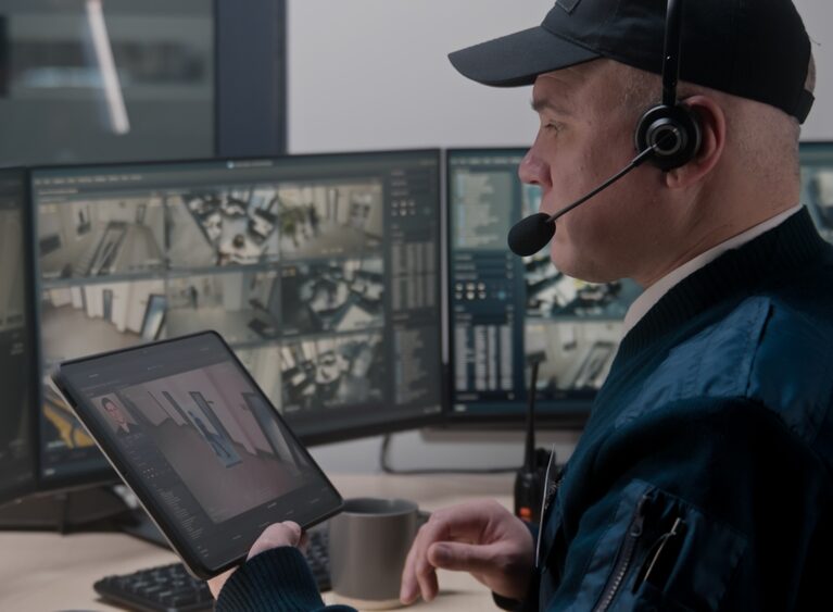 Security,Officer,In,Headset,Controls,And,Monitors,Cctv,Cameras,In